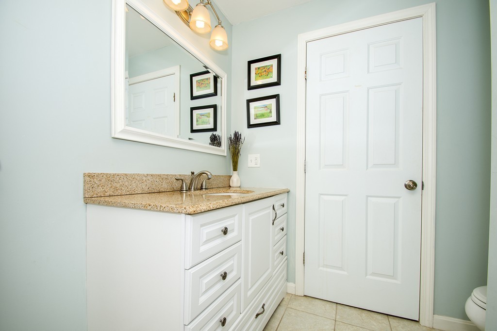 8 Seamore Road Scituate, MA 02066 - Photo 15 of 28 a bathroom with a granite countertop sink and a mirror