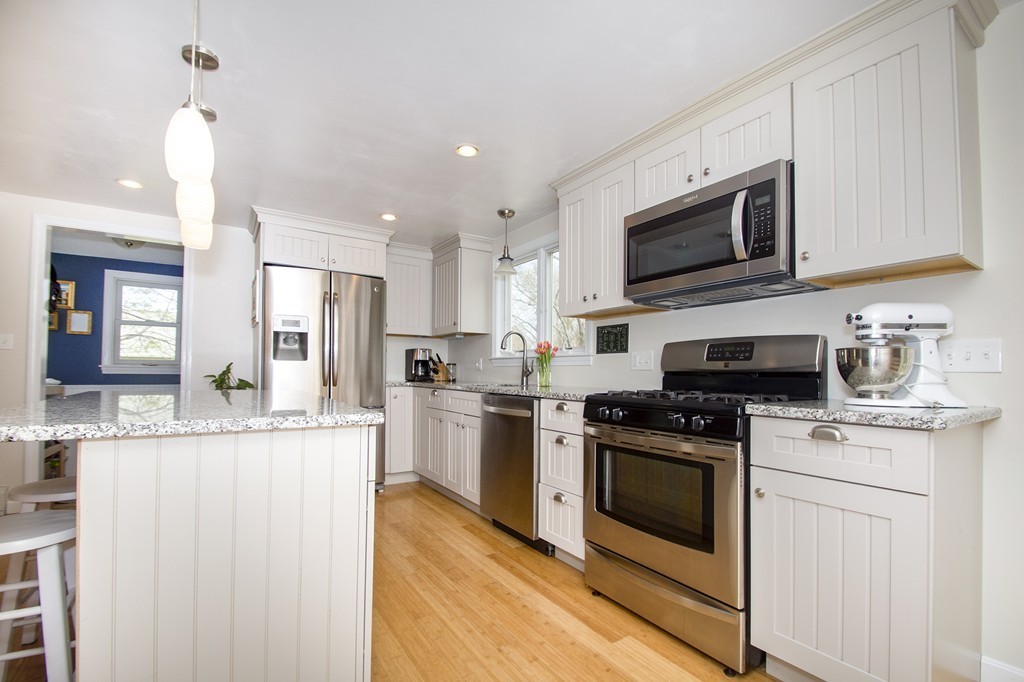 8 Seamore Road Scituate, MA 02066 - Photo 8 of 28 a kitchen with stainless steel appliances granite countertop a stove top oven a sink and a refrigerator