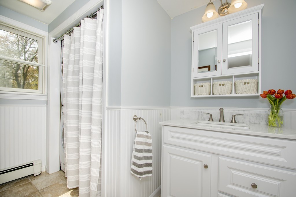 8 Seamore Road Scituate, MA 02066 - Photo 10 of 28 a bathroom with a sink a vanity and a mirror