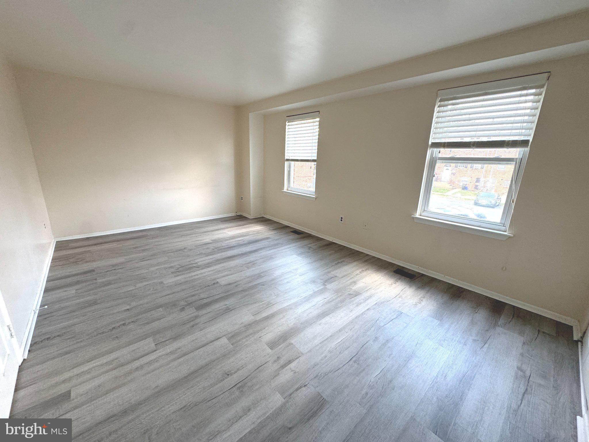 12044 Abby Road, Unit 1 Philadelphia, PA 19154 - Photo 7 of 10 a view of an empty room with wooden floor and a window