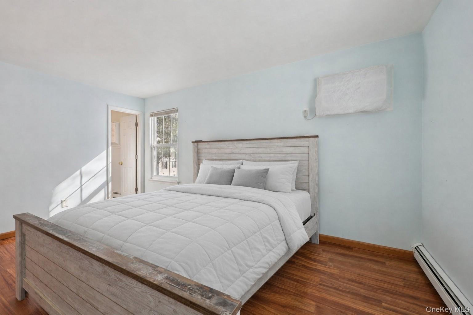 14 Lexington Hills Road, Unit 3 Harriman, NY 10926 - Photo 23 of 30 a large bed sitting in a bedroom next to a window with wooden floor