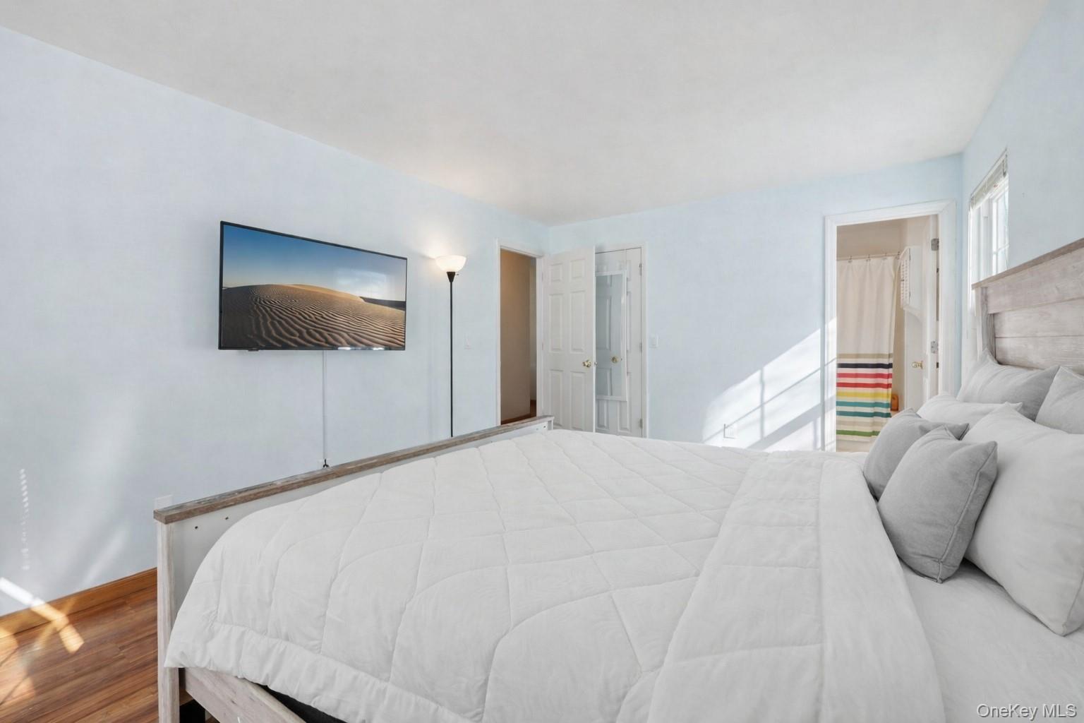 14 Lexington Hills Road, Unit 3 Harriman, NY 10926 - Photo 25 of 30 a bedroom with a bed and a flat screen tv