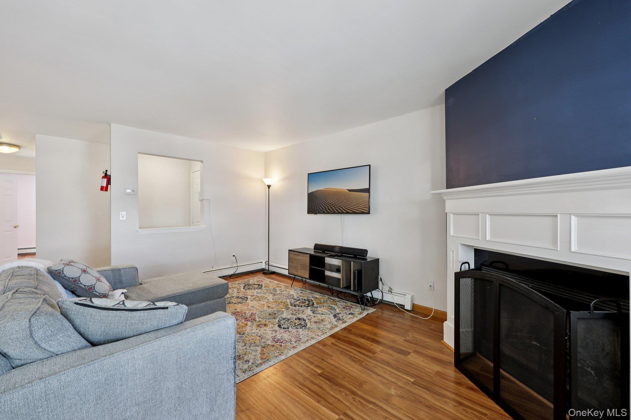 14 Lexington Hills Road, Unit 3 Harriman, NY 10926 - Photo 7 of 30 a living room with furniture a flat screen tv and a fireplace