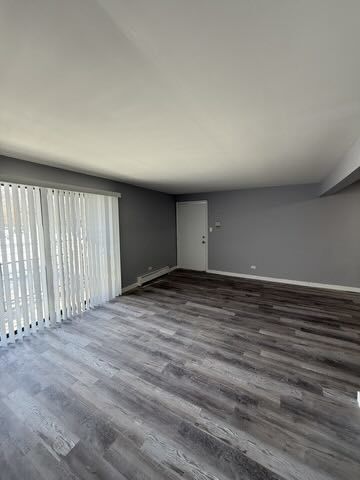 1685 Harbor Avenue, Unit 2S Calumet City, IL 60409 - Photo 2 of 5 an empty room with wooden floor and windows