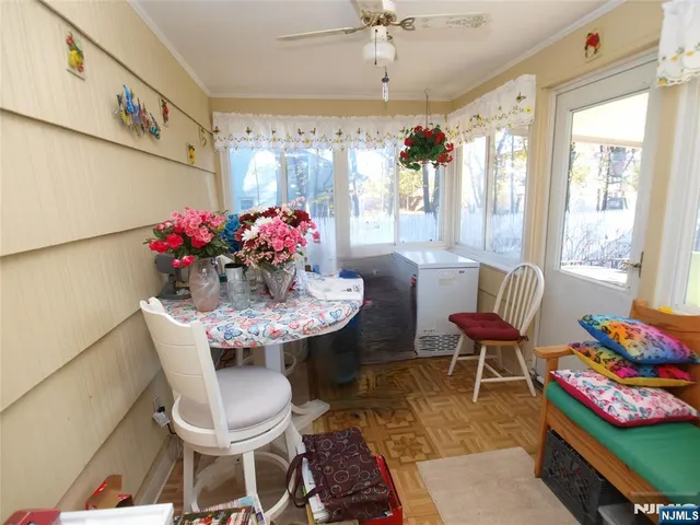 a view of a dining room with furniture and a chandelier