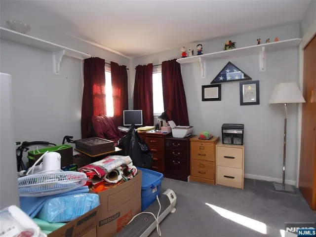 a bedroom with furniture and a window