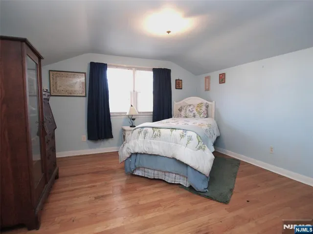 a spacious bedroom with a bed and a window