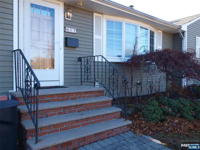 a view of a house with a small deck and wooden floor