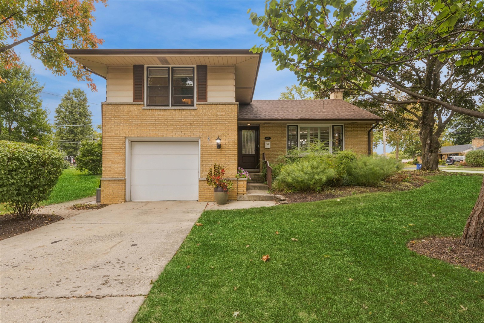 465 East Hillside Road Naperville, IL 60540 - Photo 1 of 23 a front view of a house with a garden and yard