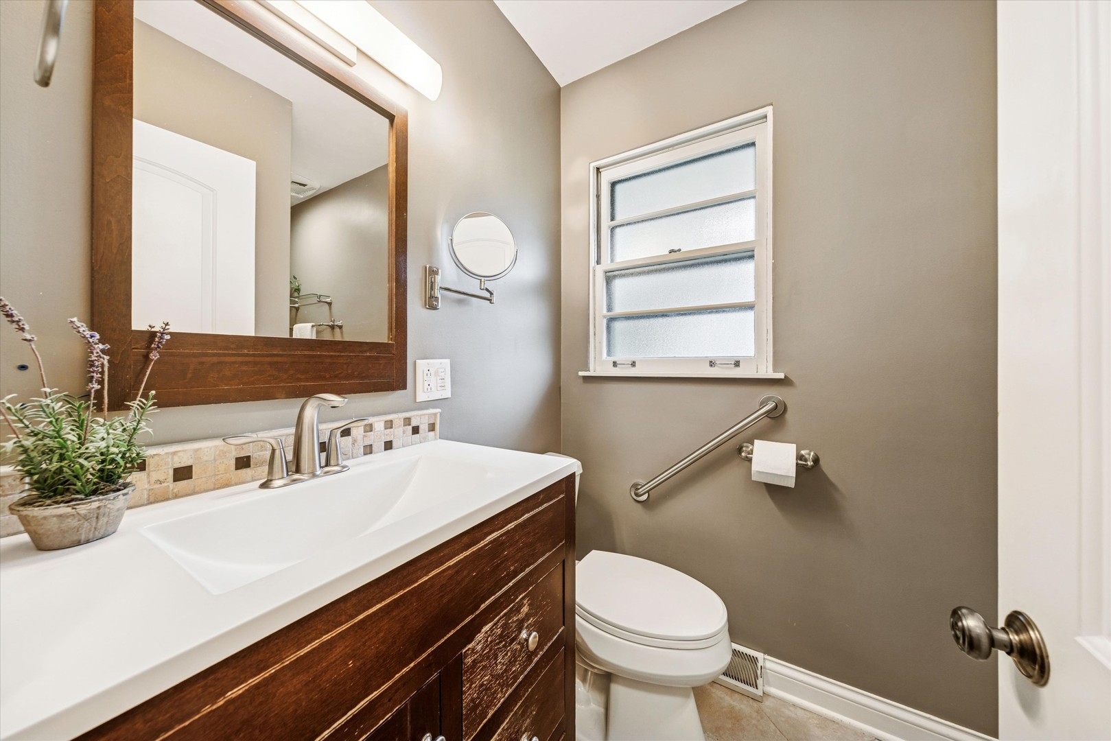 465 East Hillside Road Naperville, IL 60540 - Photo 13 of 23 a bathroom with a sink mirror vanity and toilet