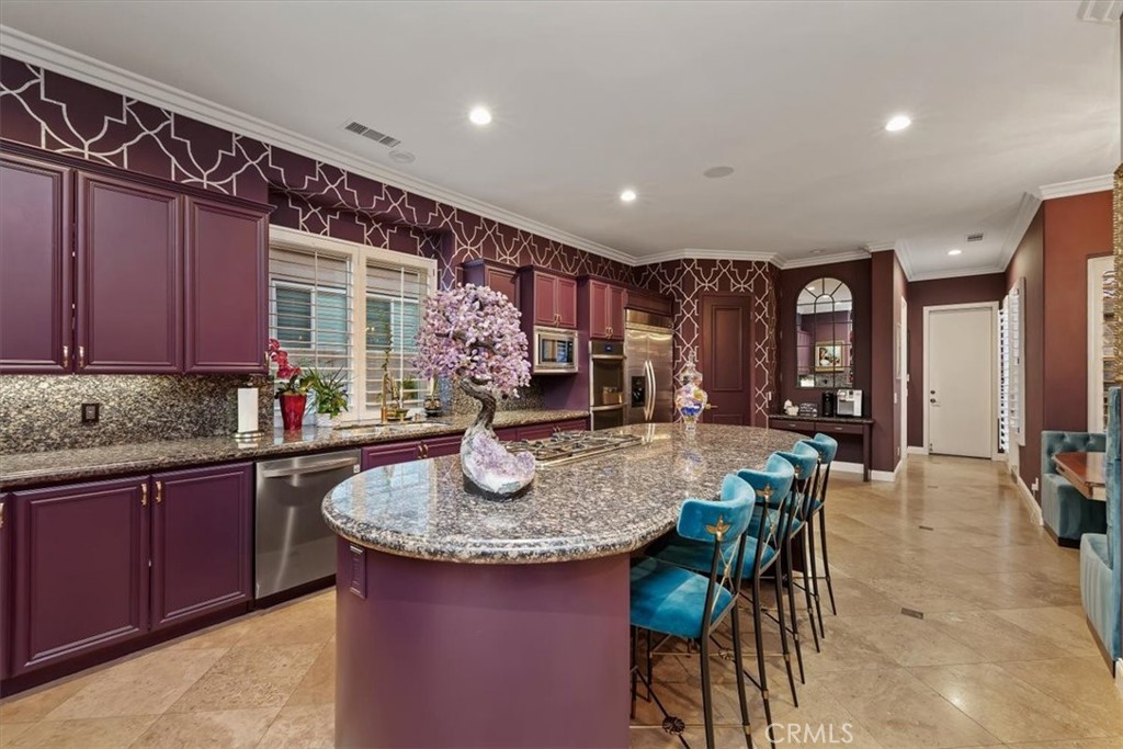 20 Vista Encantada Rancho Mirage, CA 92270 - Photo 26 of 75 a kitchen with sink a table and chairs in it