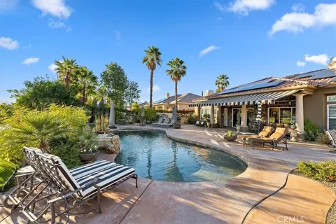 a view of a swimming pool with a lounge chairs
