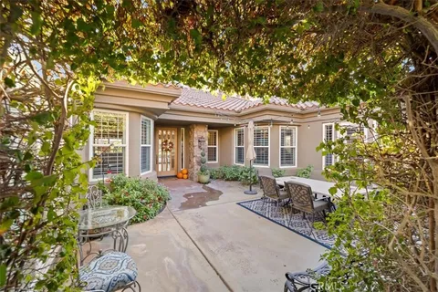 a view of a patio with table and chairs and potted plants