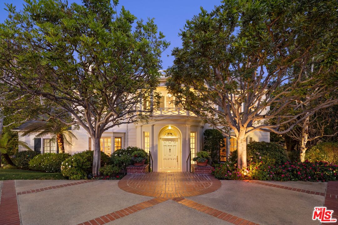 524 North Rockingham Avenue Los Angeles, CA 90049 - Photo 1 of 24 a large building with trees in front of it