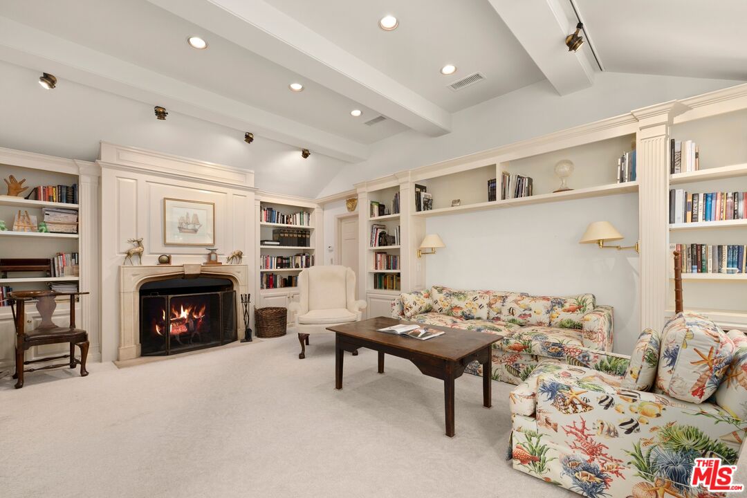 524 North Rockingham Avenue Los Angeles, CA 90049 - Photo 12 of 24 a bedroom with furniture and a fireplace