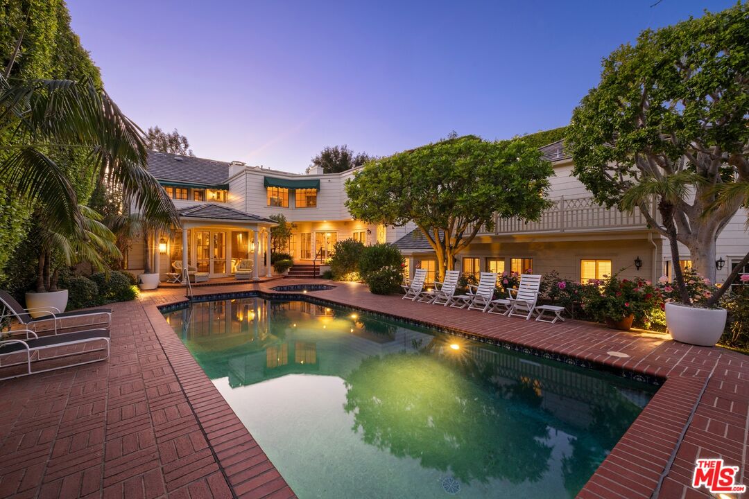 524 North Rockingham Avenue Los Angeles, CA 90049 - Photo 2 of 24 a view of a swimming pool with a lounge chairs in patio