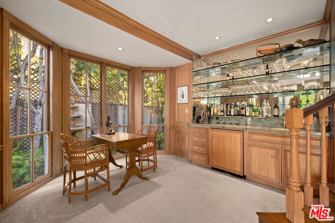 524 North Rockingham Avenue Los Angeles, CA 90049 - Photo 8 of 24 a dining room with stainless steel appliances a large window and table