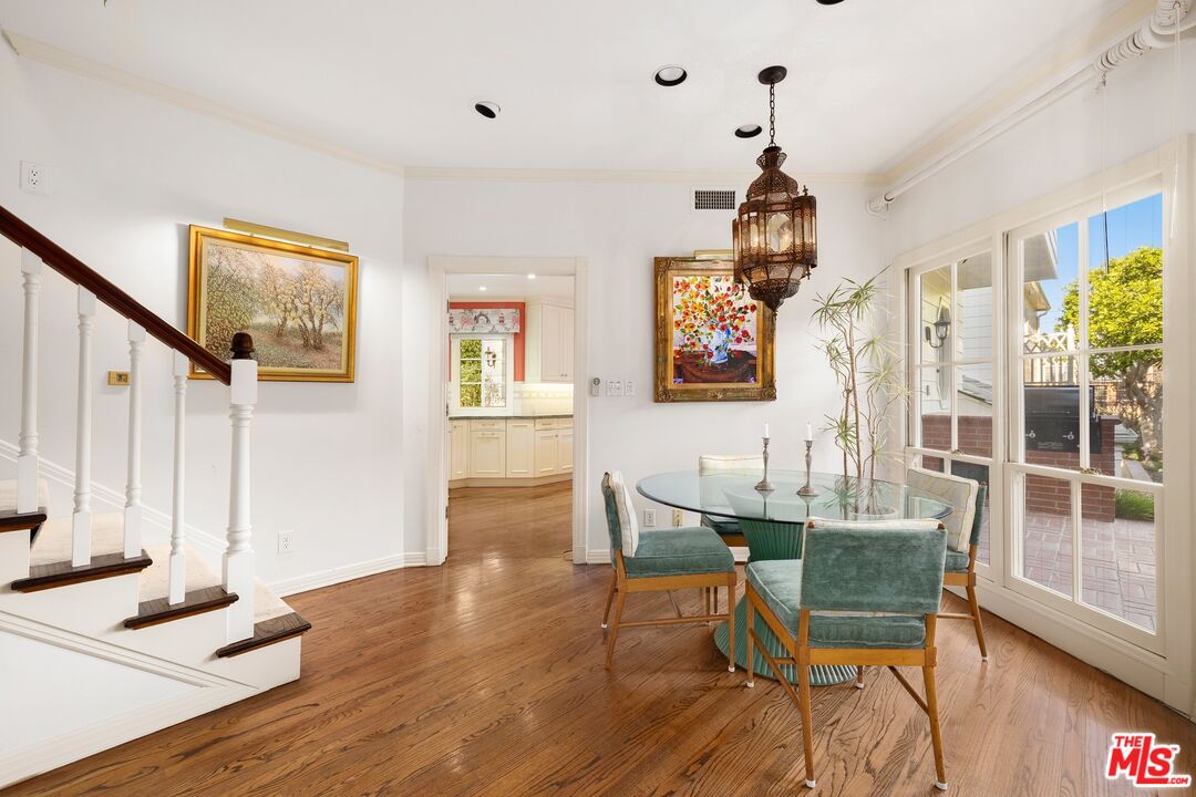 524 North Rockingham Avenue Los Angeles, CA 90049 - Photo 10 of 24 a dining room with wooden floor and entrance
