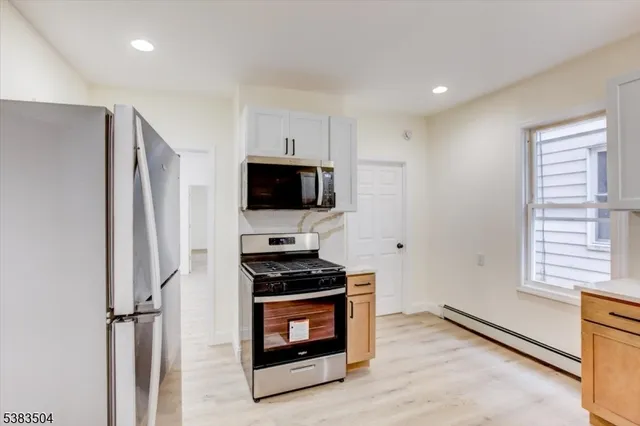 a kitchen with stainless steel appliances a refrigerator stove and microwave