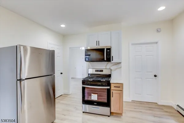 a kitchen with stainless steel appliances a refrigerator stove and microwave
