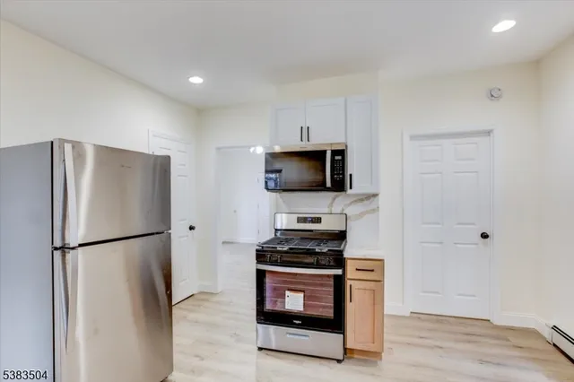 a kitchen with stainless steel appliances a refrigerator stove and microwave