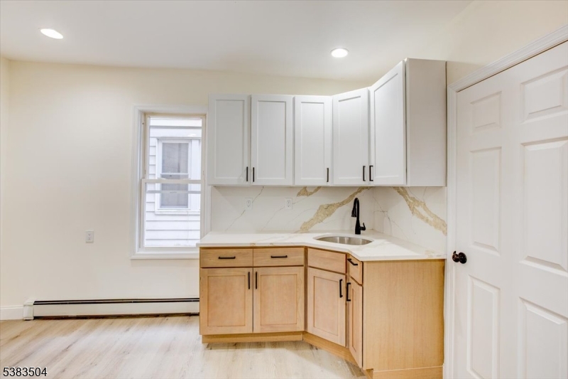 546 Morris Street, Unit 1 Orange, NJ 07050 - Photo 14 of 17 a kitchen with a sink cabinets and window