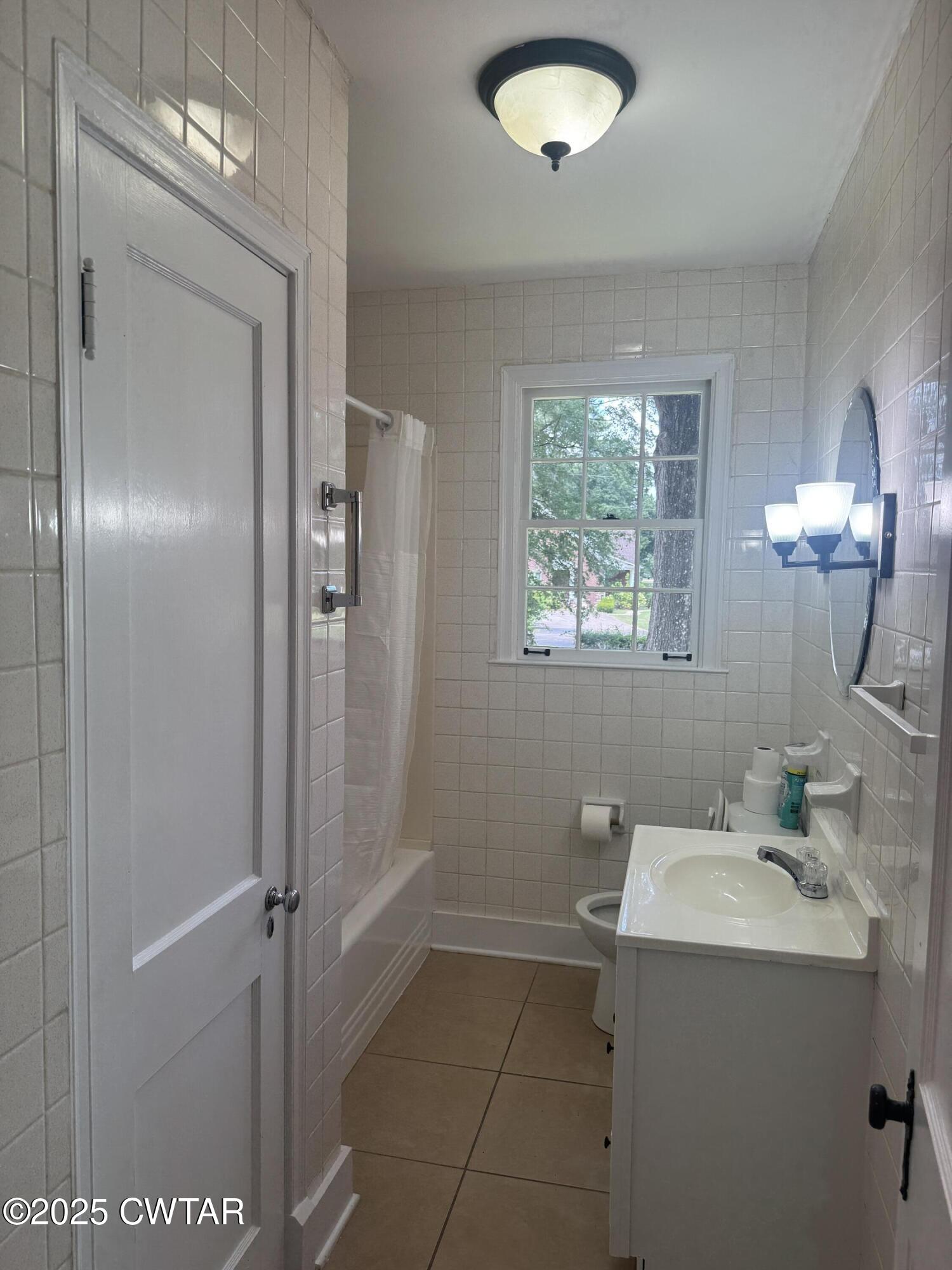 511 White Avenue Henderson, TN 38340 - Photo 16 of 28 a bathroom with a sink a toilet and shower