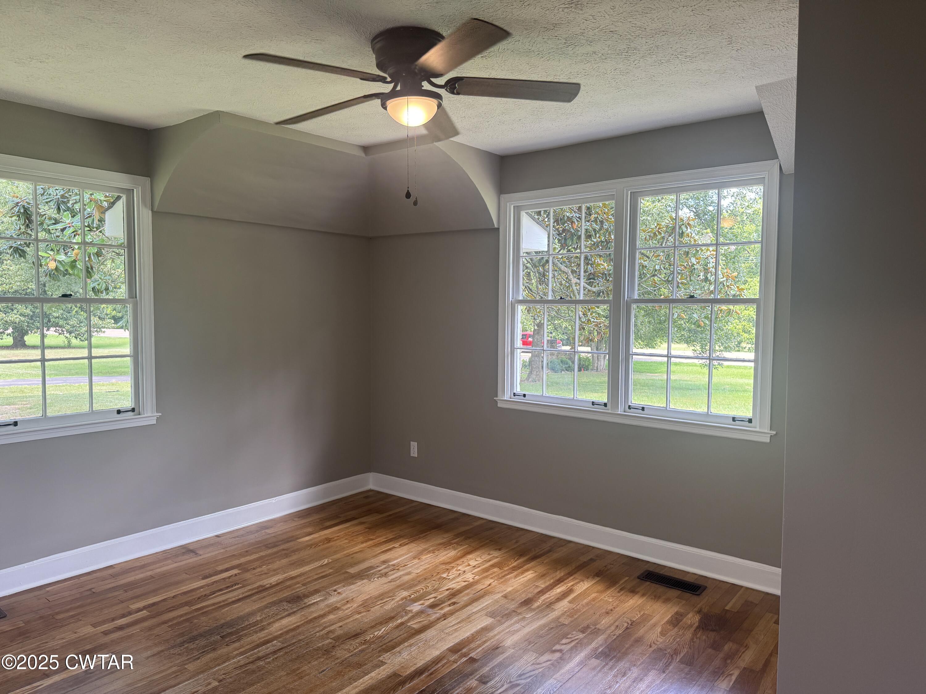 511 White Avenue Henderson, TN 38340 - Photo 17 of 28 a view of empty room with wooden floor and fan
