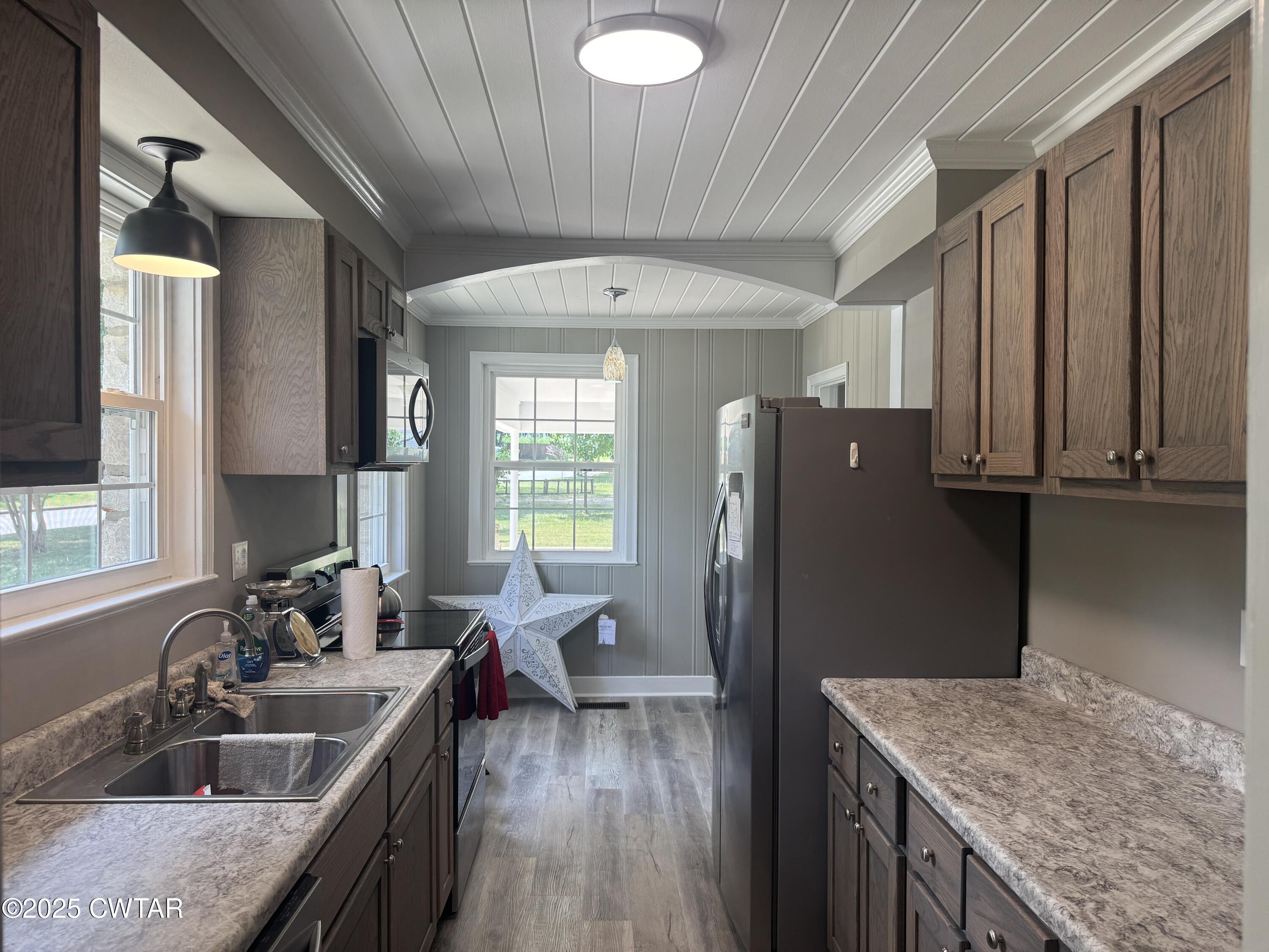 511 White Avenue Henderson, TN 38340 - Photo 21 of 28 a kitchen with refrigerator and window