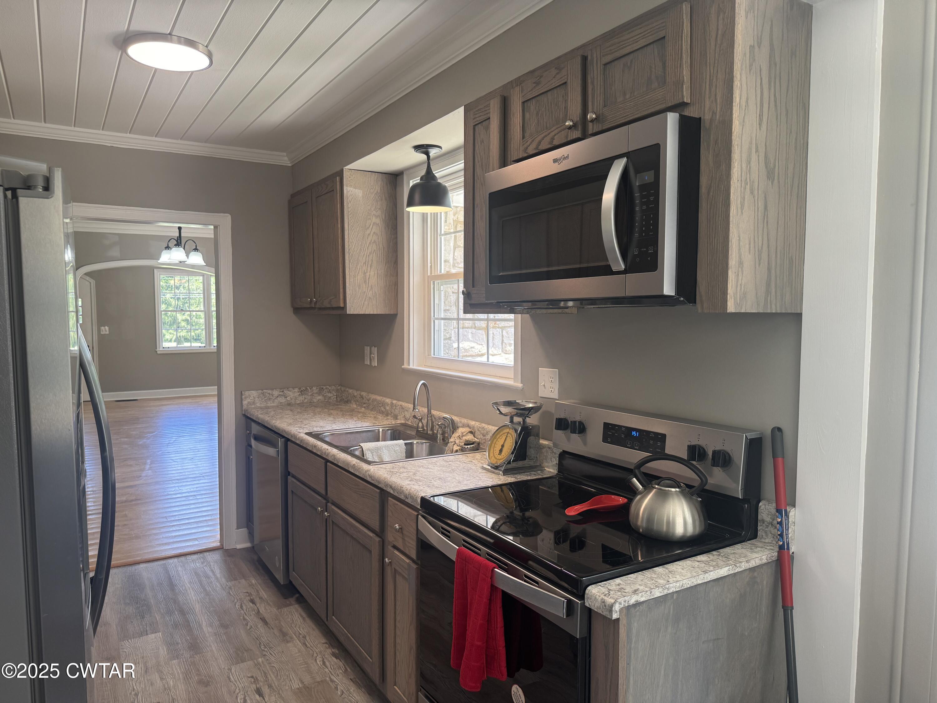 511 White Avenue Henderson, TN 38340 - Photo 22 of 28 a kitchen with stainless steel appliances granite countertop a stove and a microwave