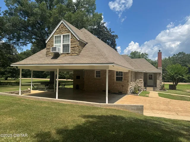 a front view of a house with a yard table and chairs