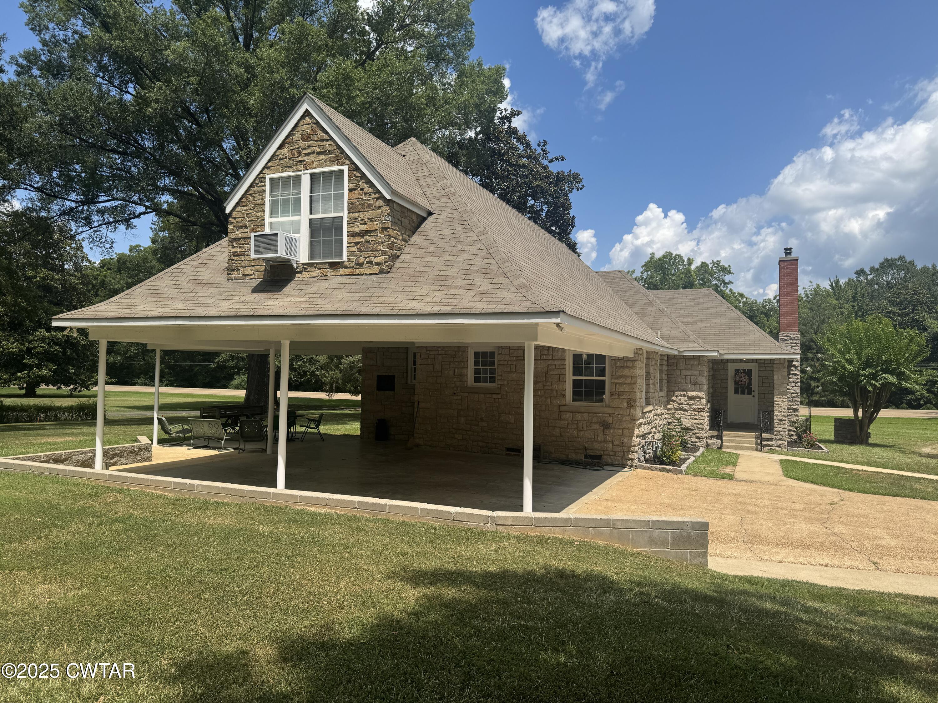 511 White Avenue Henderson, TN 38340 - Photo 8 of 28 a front view of a house with a yard table and chairs