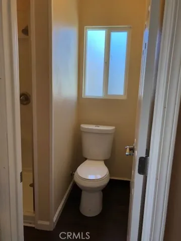 a bathroom with a toilet and a shower