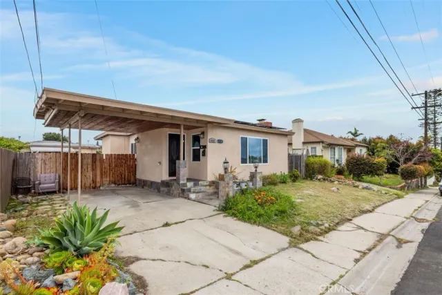 a view of a house with backyard and sitting area