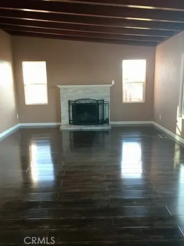 a view of empty room with window and fireplace