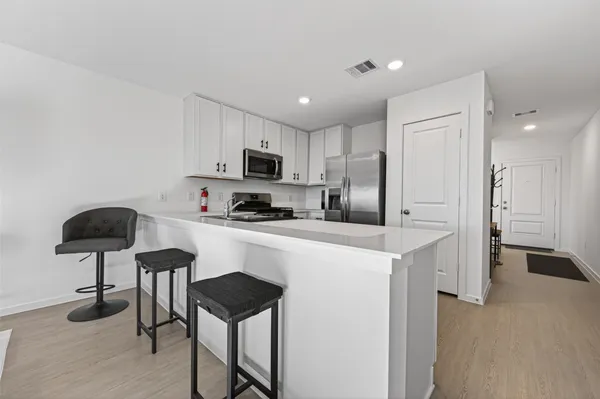 a kitchen with kitchen island cabinets and refrigerator