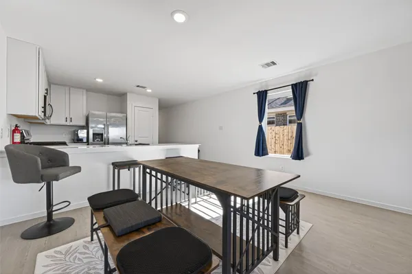 a kitchen with sink and chairs