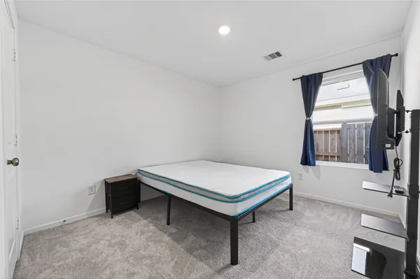 a room with pool table and windows
