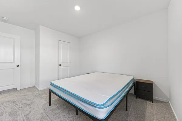 a bedroom with a bed and a table