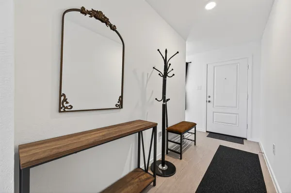 a view of hallway with furniture and a potted plant