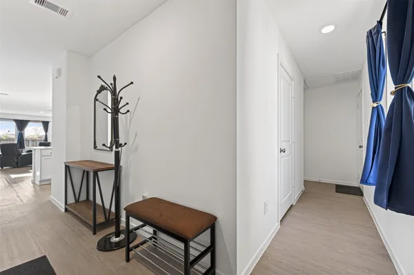 a view of a hallway with furniture and entryway