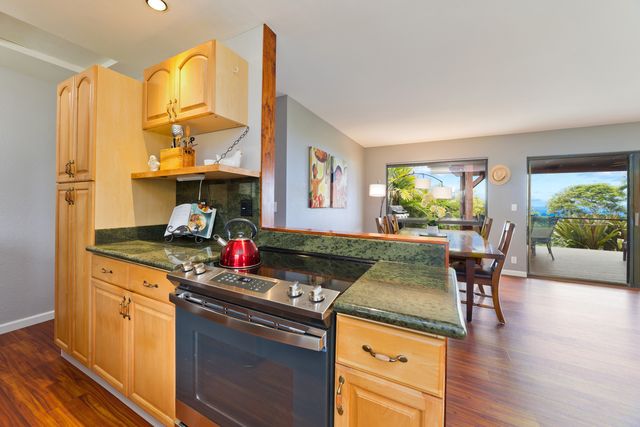 a kitchen that has a sink and a wooden floor