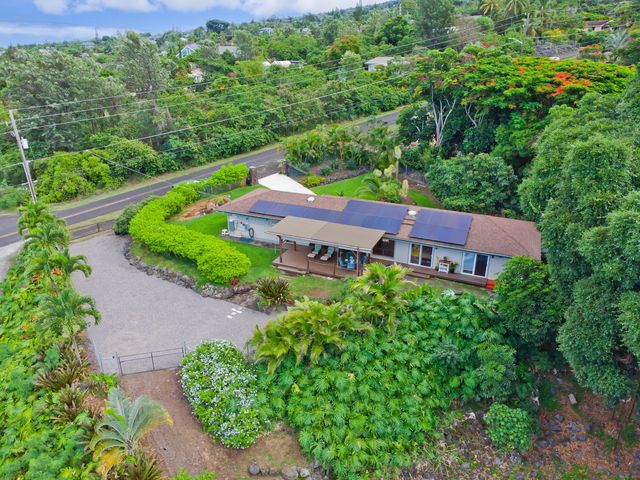 an aerial view of a house with a yard