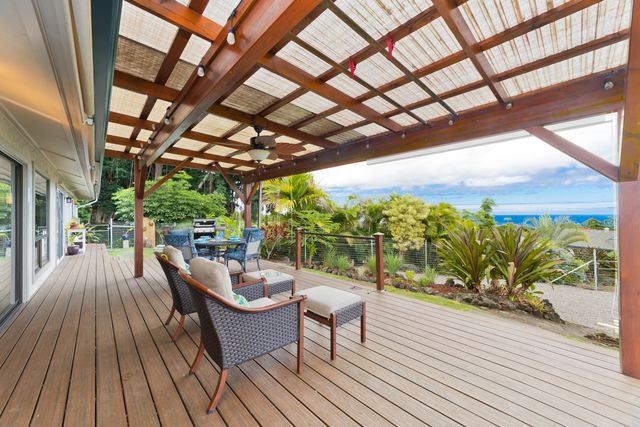 a balcony with furniture and wooden floor