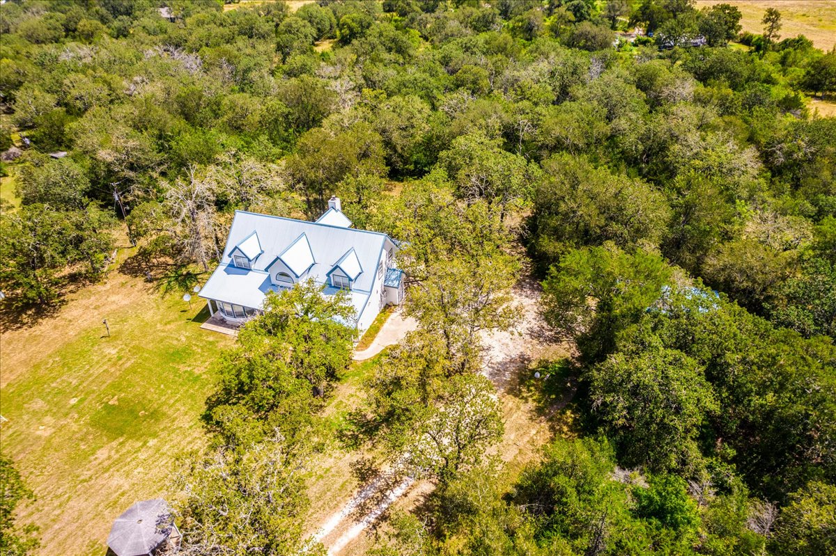 19106 Eyerley Road Manor, TX 78653 - Photo 36 of 40 Nestled amidst verdant woods, a charming home offers peaceful seclusion.