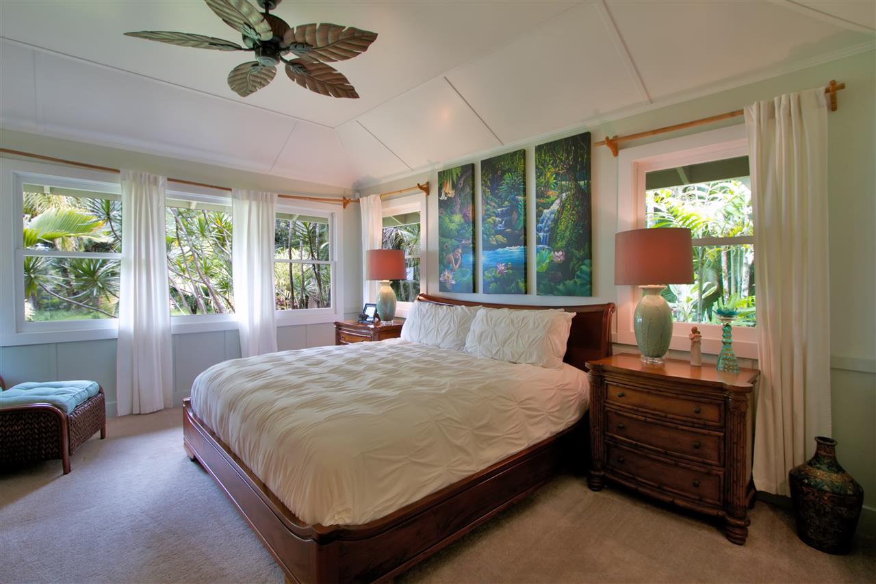 261 Awalau Road Haiku, HI 96708 - Photo 4 of 29 a large bed sitting in a bedroom next to a window