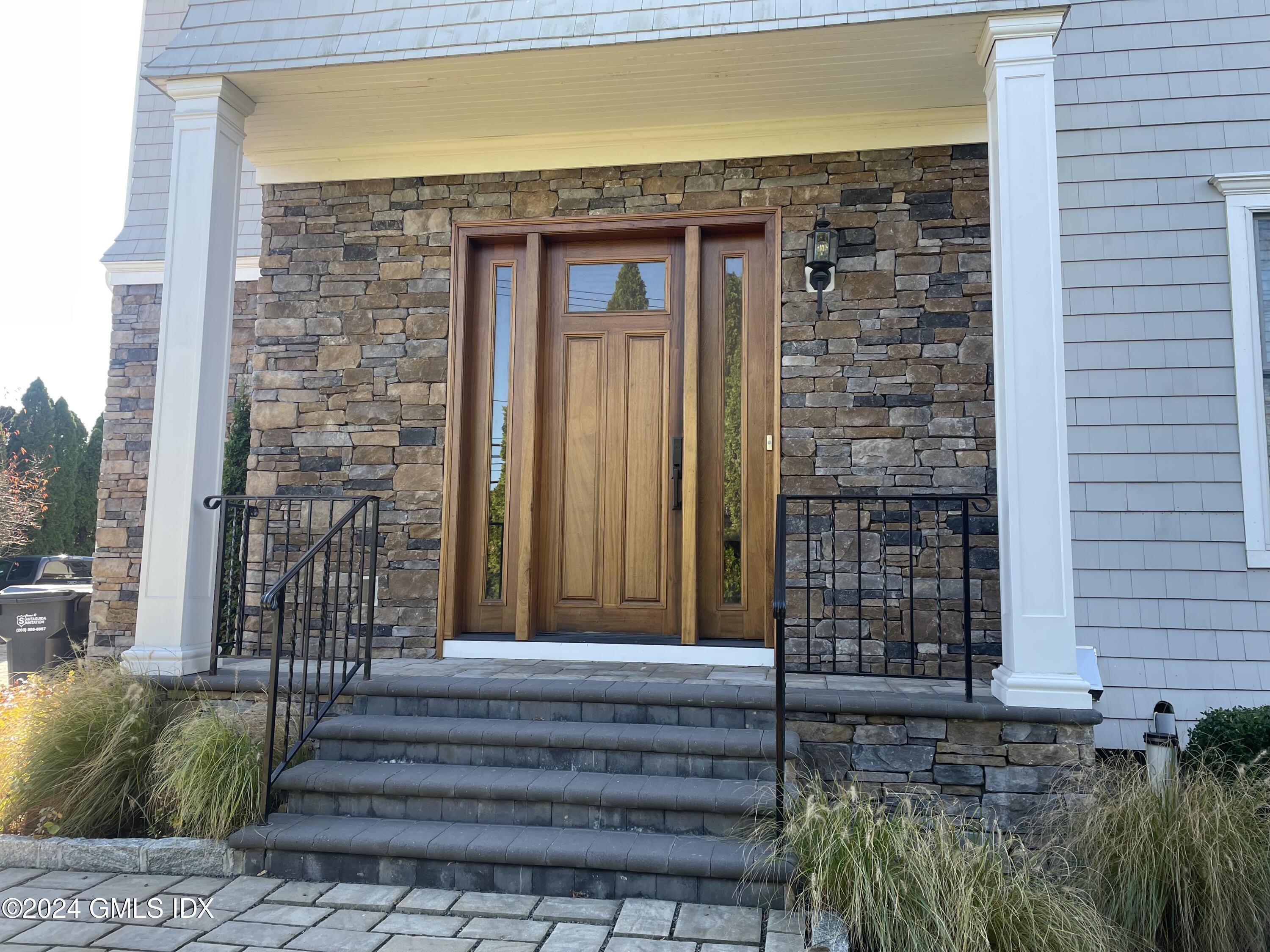 8 Sound Beach Ave Extension, Unit 1 Riverside, CT 06878 - Photo 2 of 31 a front view of a house with a garden