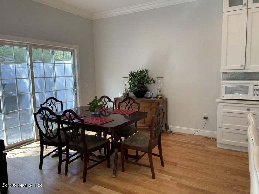 8 Sound Beach Ave Extension, Unit 1 Riverside, CT 06878 - Photo 7 of 31 a view of a dining room with furniture and wooden floor