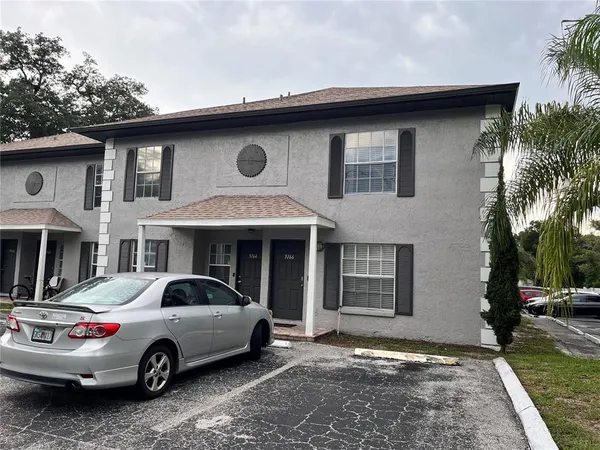 a front view of a house with parking space