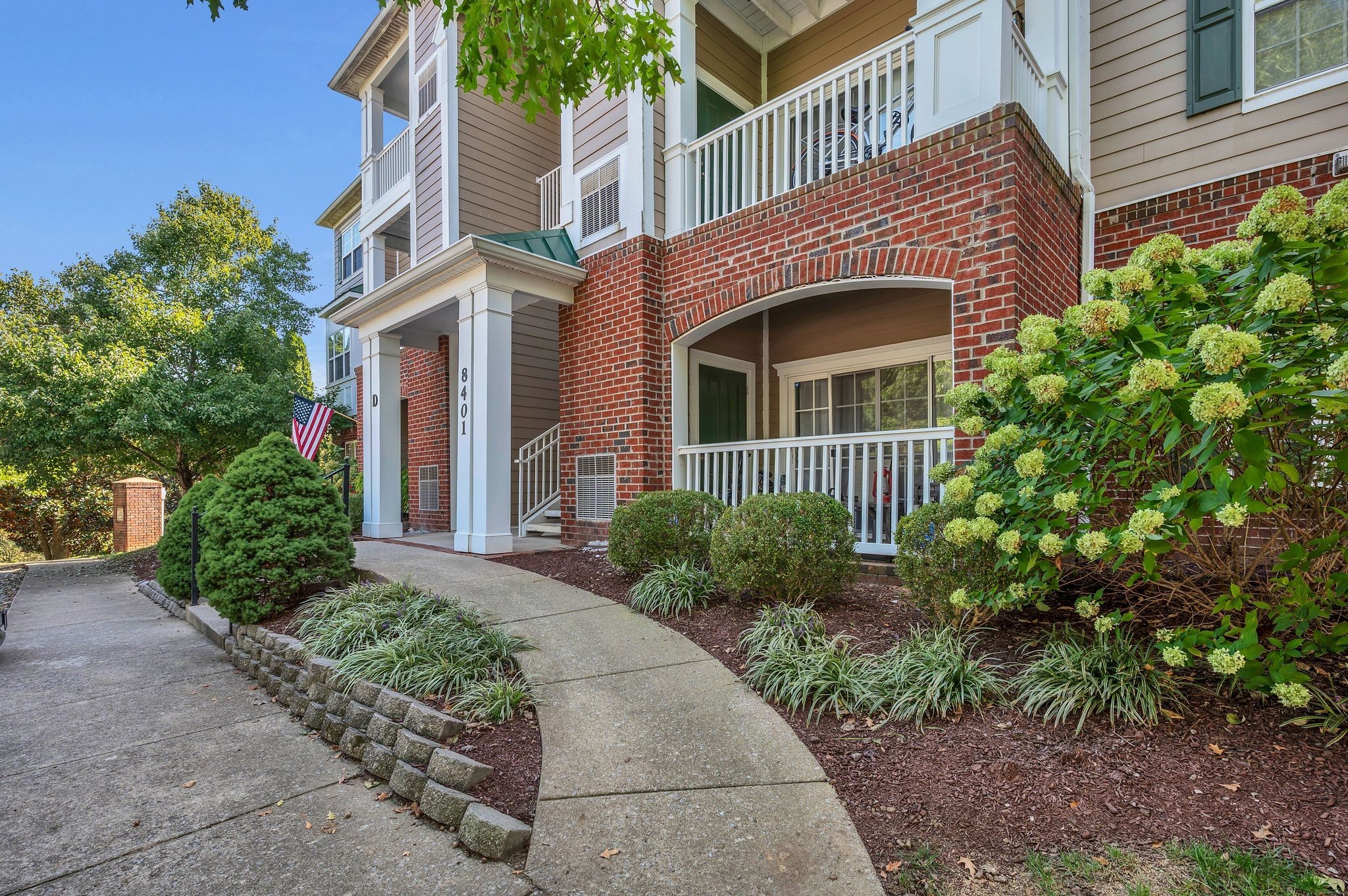 a front view of a house with a garden